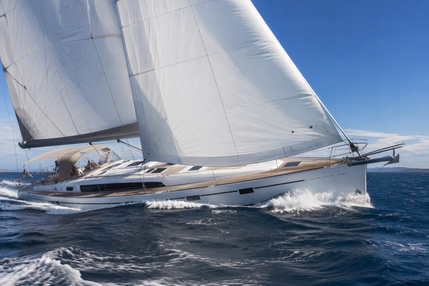 Trade Wind Pearl — elegant white sailing yacht with full sails gliding across the ocean